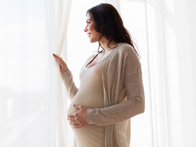 pregnant woman getting ready to move to a new home