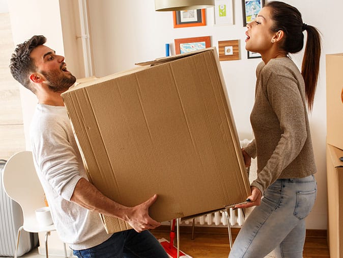 birmingham couple struggling to carry heavy moving box
